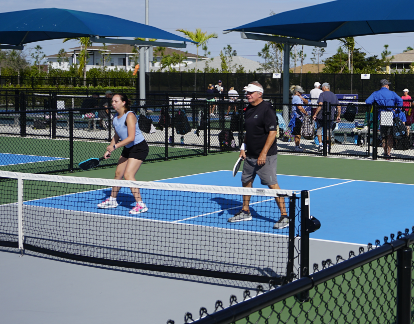 Group playing pickleball outdoors fun